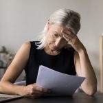 Frustrated female business owner applying for a SBA loan.