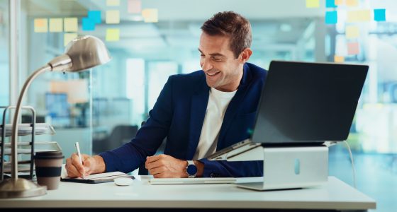 Confident businessman selling a business smiles as he works.