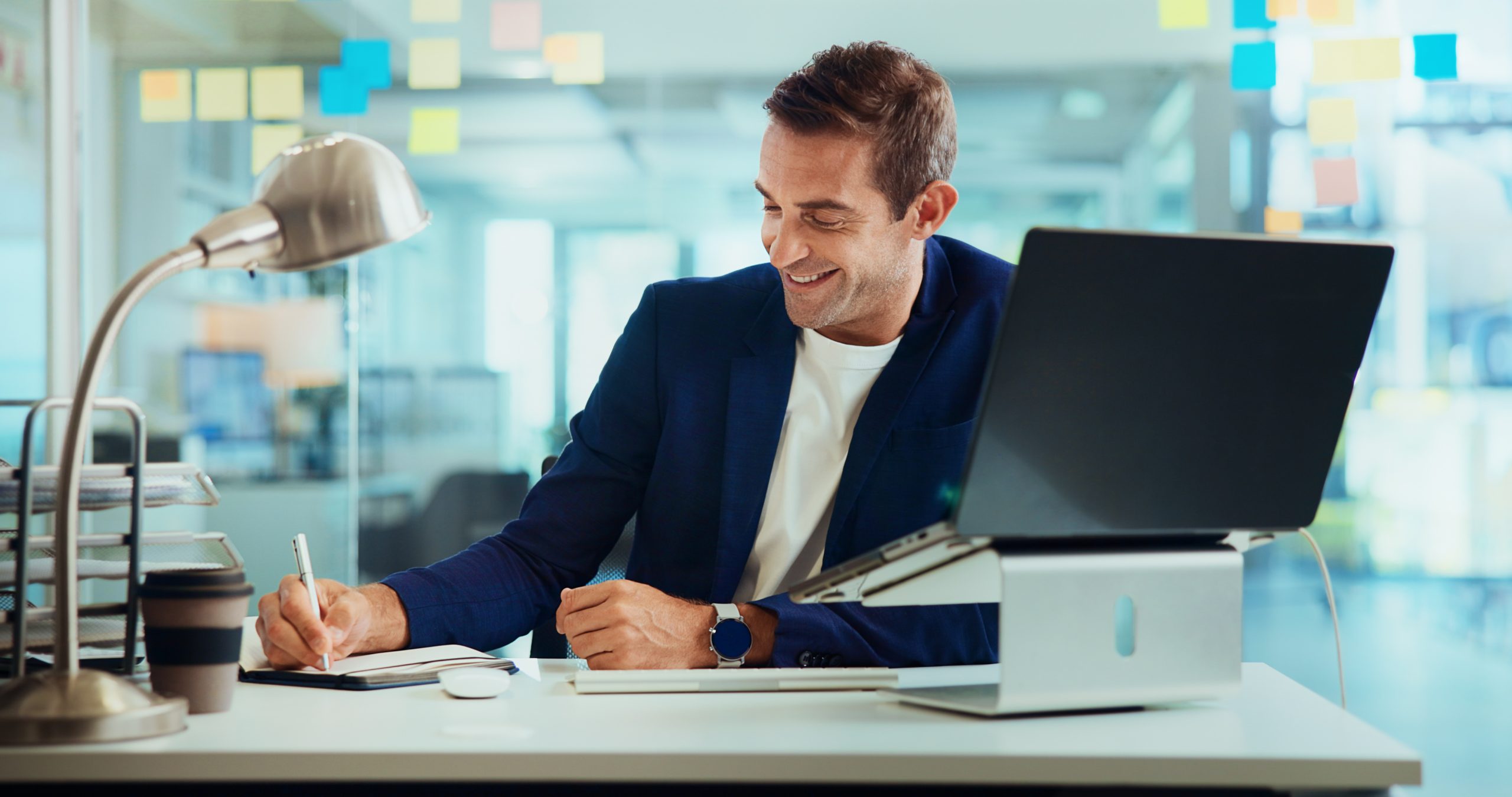 Confident businessman selling a business smiles as he works.